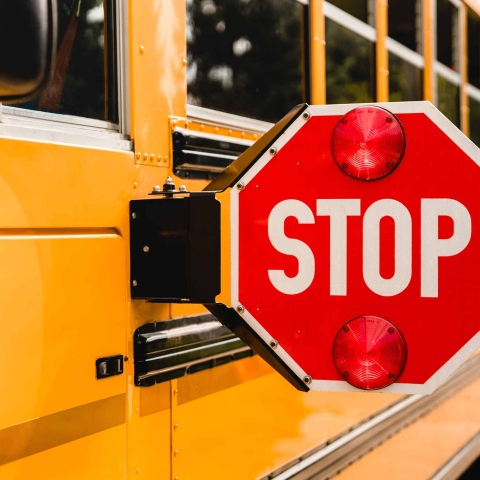 A school bus with its stop sign extended