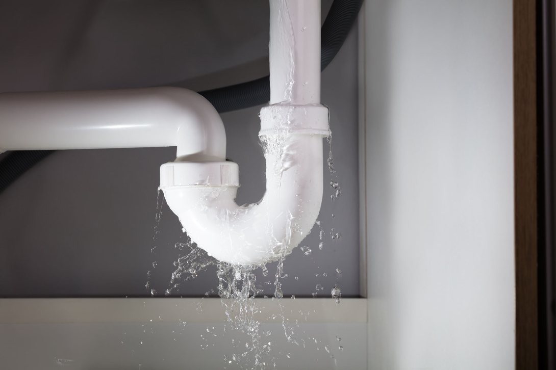 Water leaking from a white pipe